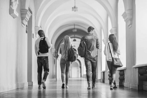 Graduate students walking down a hall. 