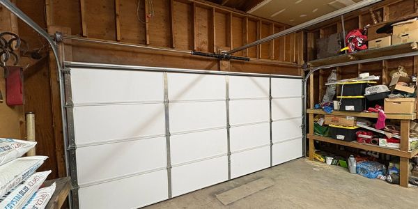 Newly installed white insulated residential garage door interior with torsion spring system by Heavy Metal Door in Spokane, WA.