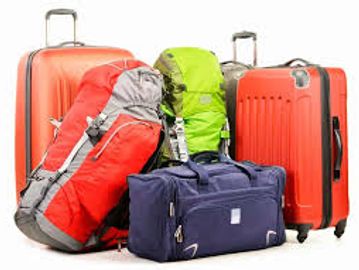 Various colorful travel bags and suitcases grouped together.