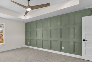 A serene master suite transformation featuring a sage green grid-pattern accent wall. This custom wo