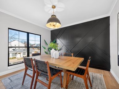 A bold statement in modern design. This flex room features a floor-to-ceiling geometric accent wall 