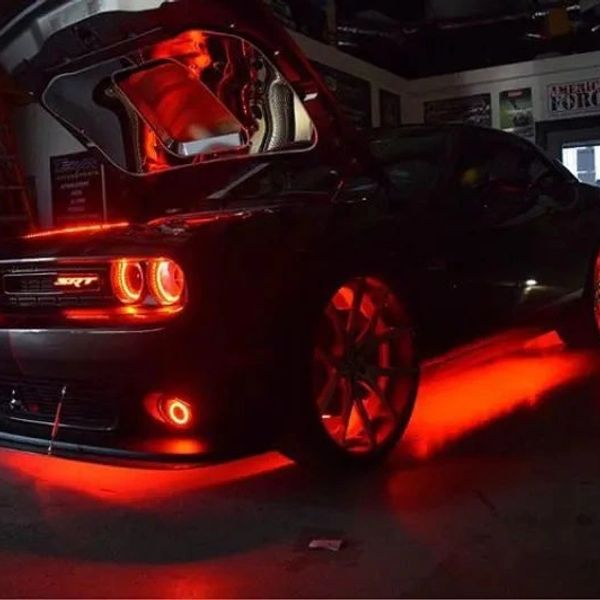 Black sports car with striking red underglow and illuminated headlights.