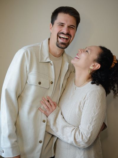 Happy couple laughing together, sharing a joyful moment.
