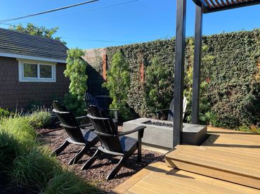 Fire pit connected to floating deck outdoor dining