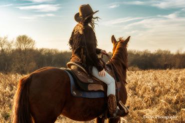 Woman riding a horse in a field