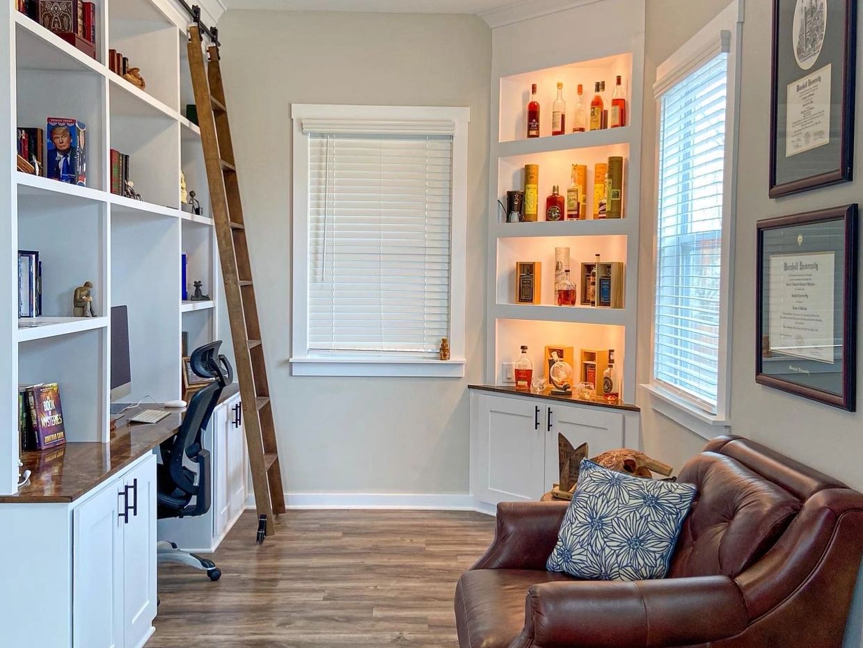Custom Office with bourbon cabinet, hand-made library ladder, and functional storage.