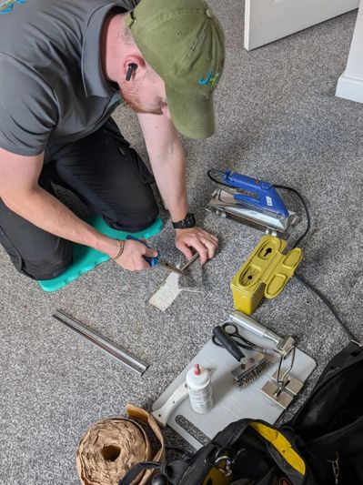 employee repairing carpet 