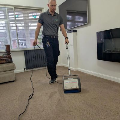 employee cleaning a carpet 
