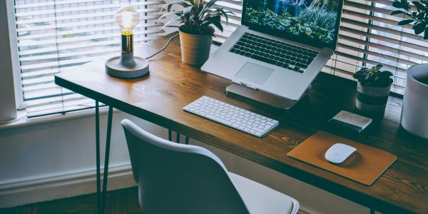 Minimalist workspace with a laptop and lamp.
