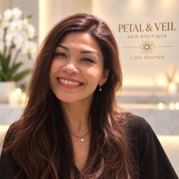 Smiling woman with long hair and earrings.