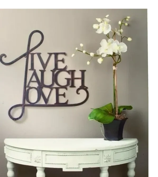 Live Laugh Love sign board above the table