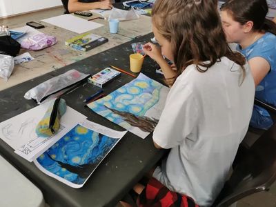 Children in a kids art class at Woolgoolga Gallery,  using art materials in a guided creative class.