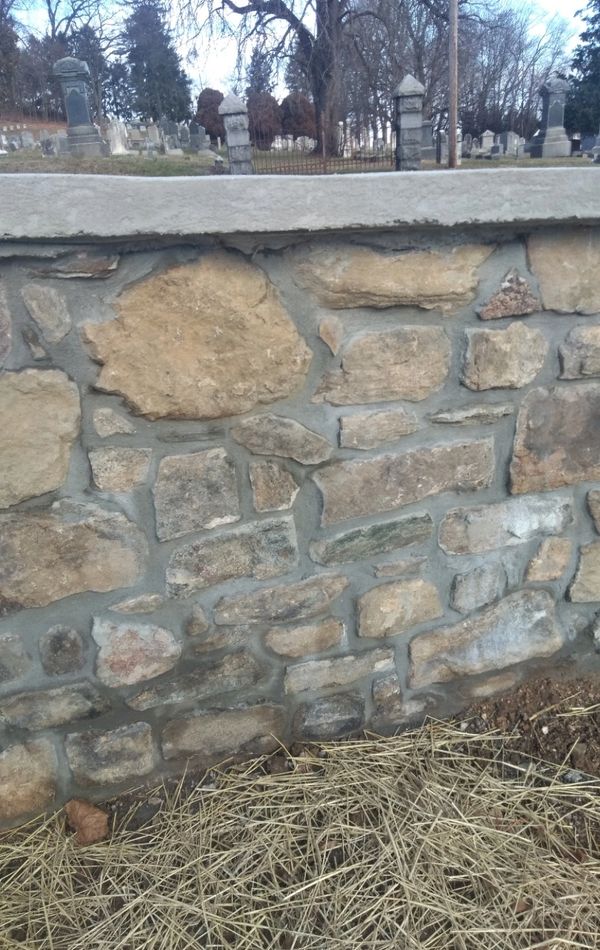 Stone wall in graveyard capped wall