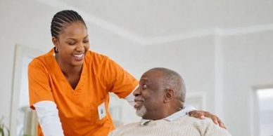 recreational activities where caretaker showing elderly how to use laptops