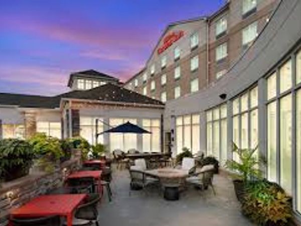 Outdoor seating area at a hotel during sunset.