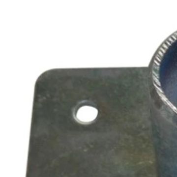 Close-up of a metal bracket with a screw hole.