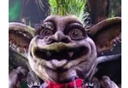 A whimsical creature with exaggerated features and grass-like hair.