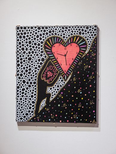 Abstract heart-shaped clock with colorful patterns on a split black and white dotted background.
