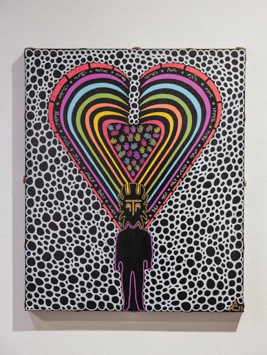 Silhouette with colorful heart-shaped patterns and abstract designs on dotted background.