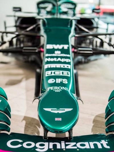 Close-up of a Formula 1 car nose with sponsor logos in black and white.