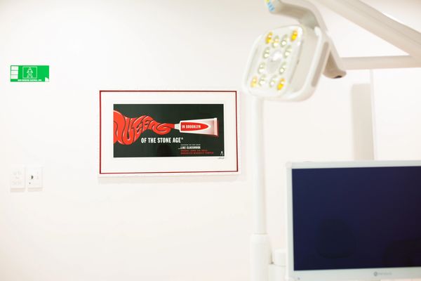 A piece of artwork in a bright room with a dental chair light and screen. 