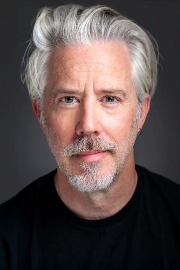 Portrait of a middle-aged man with gray hair and beard.