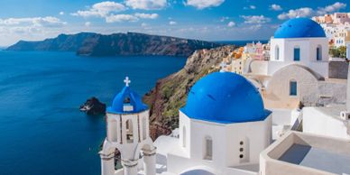 Blue-domed buildings overlooking the sea in Santorini, Greece.