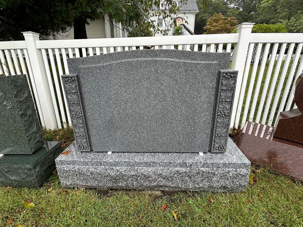 Blank gray granite tombstone in a cemetery.