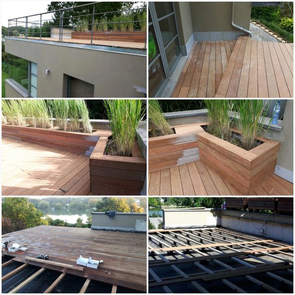 Wooden terrace construction with planter boxes and railing on a rooftop.