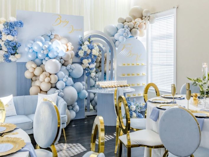 Baby Blue Balloon Backdrop and gold chairs 