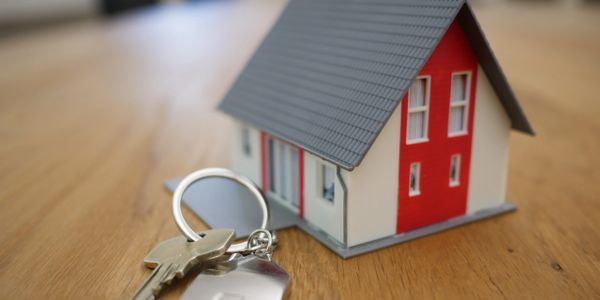 A small house with keys in front of it.