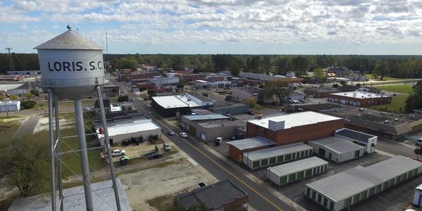 Aerial view of Loris, South Carolina with a water tower in the foreground.