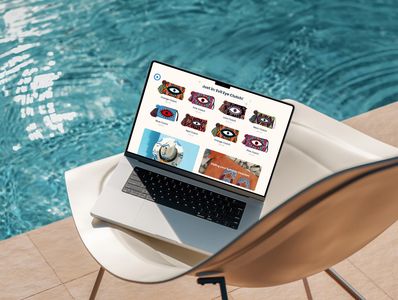 a laptop placed on a chair in front of a pool, showing web design example of a website