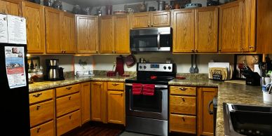 Cozy kitchen with wooden cabinets and stainless steel appliances.