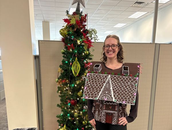 Image of media manager wearing a gingerbread house sweater.