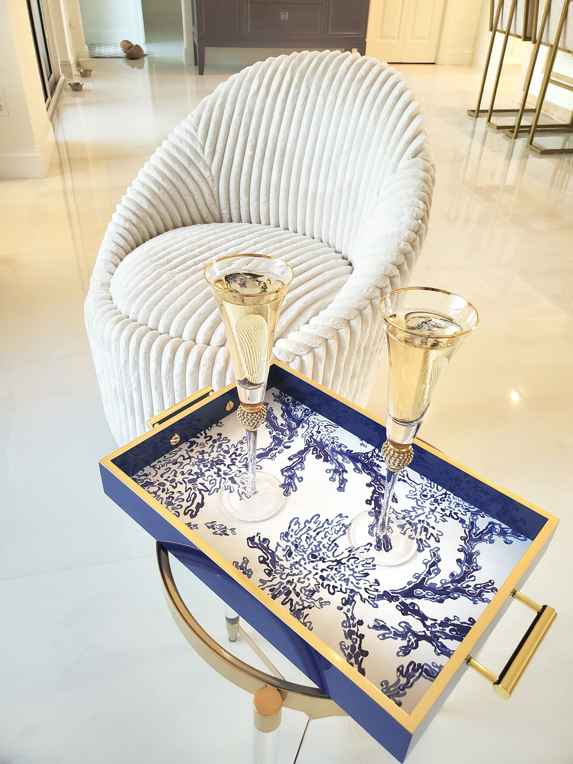 Elegant setting with two champagne glasses on a decorative tray.