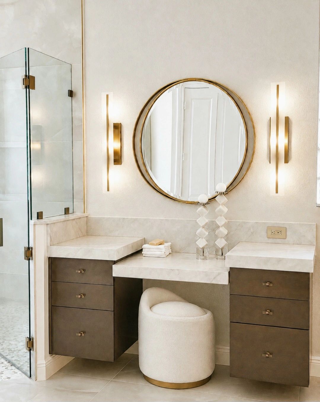 Modern vanity with round mirror and plush stool.
