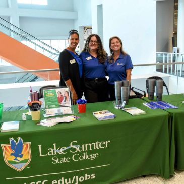 Three women at a Lake-Sumter State College booth.
