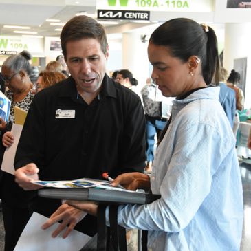 Two people engaged in a discussion at an indoor event.