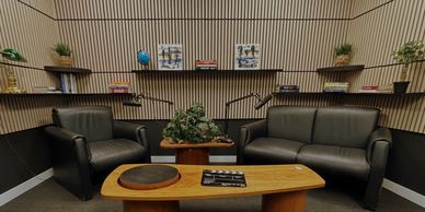 Conversation recording studio at Ottawa Podcasts with two-person couch seating and coffee table for 