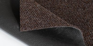 Close-up of a rolled brown textured fabric with black backing.