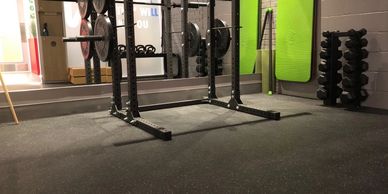 Empty gym rack with weights and mirror.
