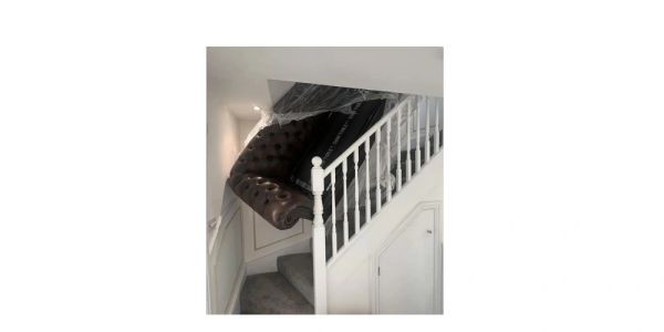 Couch stuck on a staircase.