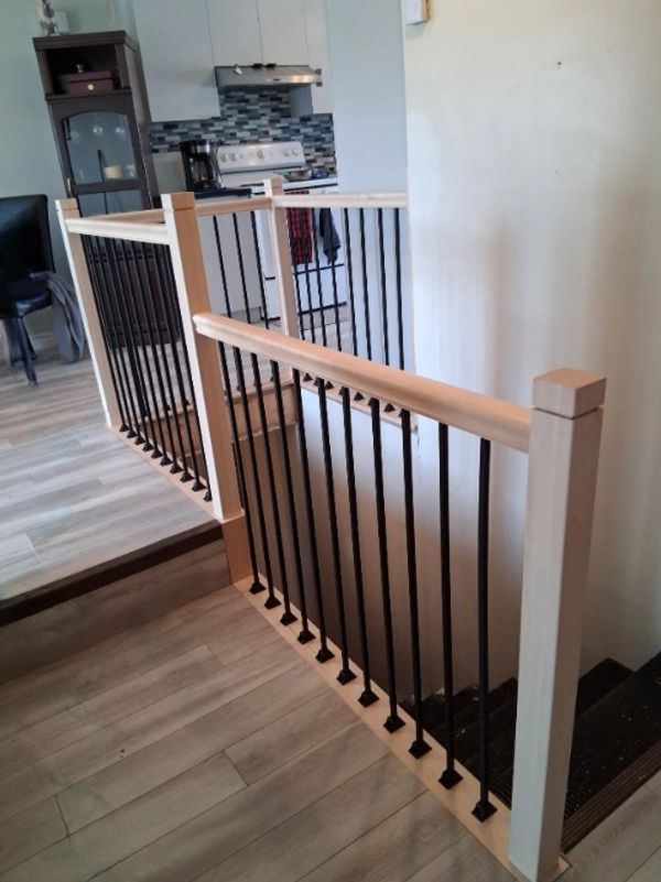 Modern wooden and metal staircase railing inside a home.