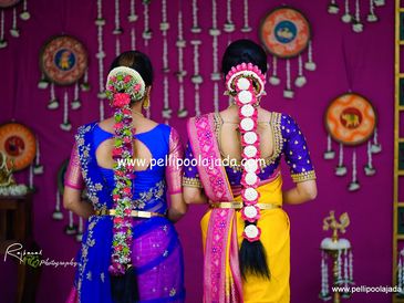Sisters wearing orchid, chrysanthemum and rose petal poolajada for wedding