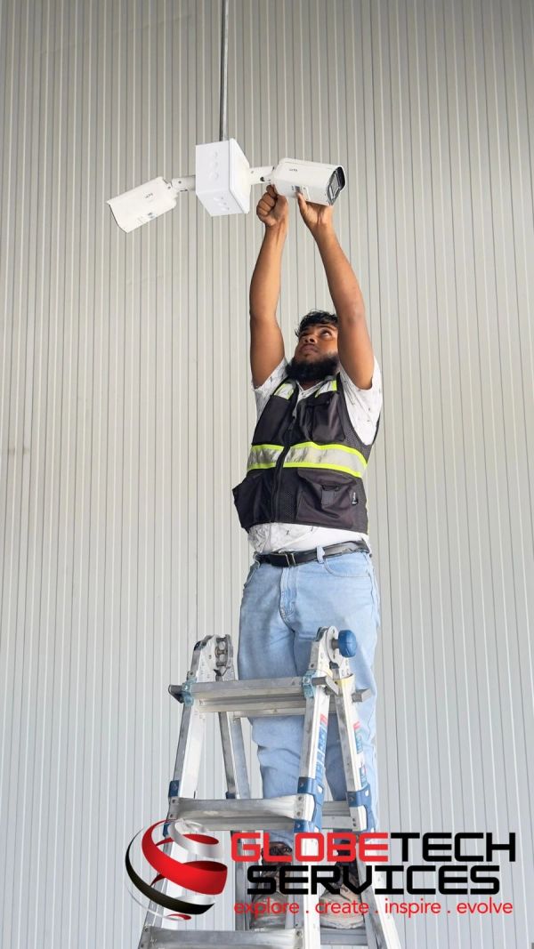 Technician installs security cameras on ceiling.