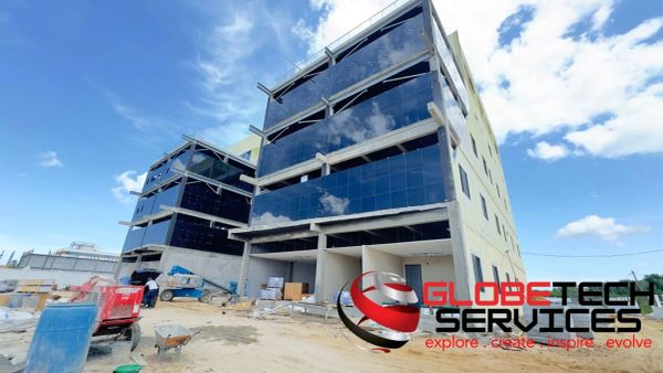 Modern office buildings under construction on a sunny day.