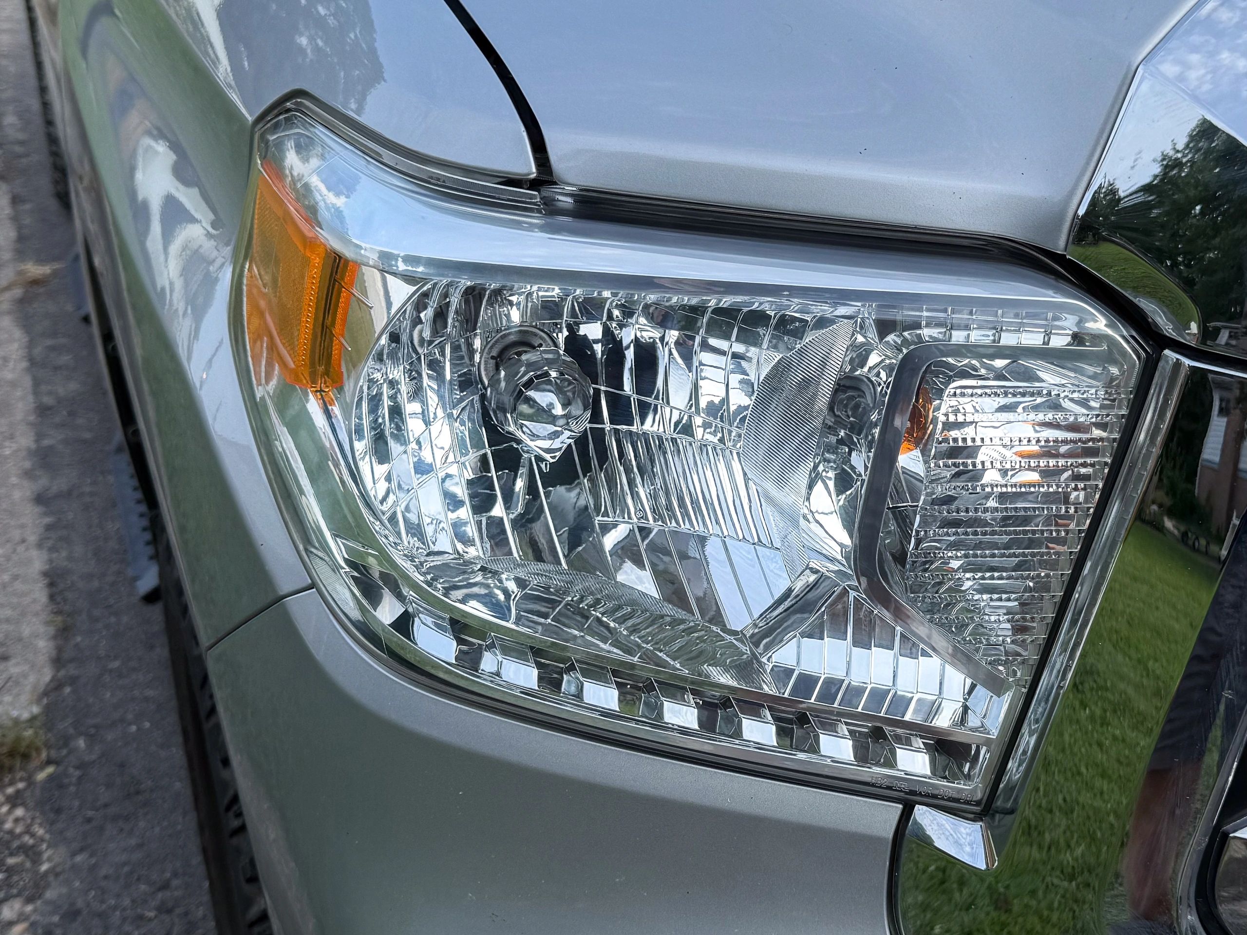 Close-up of a silver car's clean and clear headlight that has been restored by All Clear VA