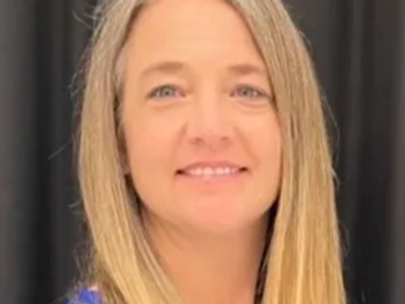 Smiling woman with long blonde hair.