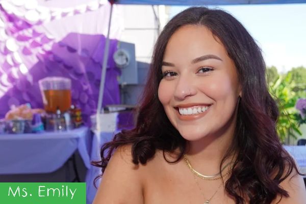 Smiling woman at a festive outdoor event.